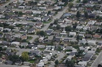 Home sales in British Columbia fell by almost 10 per cent in March compared with the same period last year, in a slowdown an analyst says could be buyers waiting for lower interest rates. Houses are seen in an aerial view in a residential neighbourhood, in Kamloops, B.C., Monday, Sept. 11, 2023.