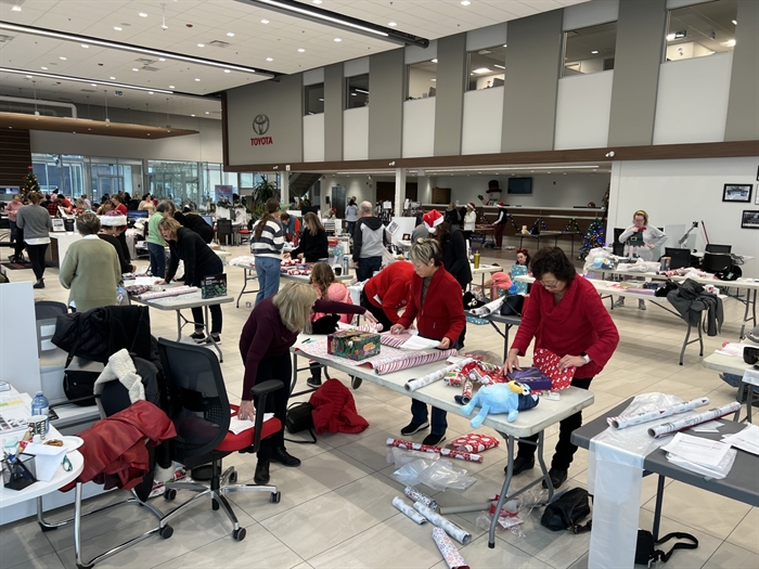 Kelowna Toyota staff wrapping presents for annual Santas event