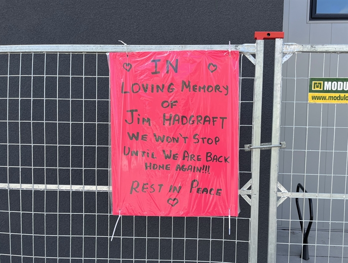 A memorial sign for Jim Hadgraft posted outside of Hadgraft Wilson Place.