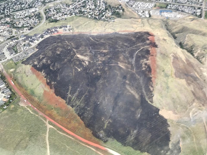 A photo of the Batchelor Heights fire on Thursday, June 21, 2018 showing the fire retardant lines from the air tanker drops. At its peak, the fire was estimated at 60 hectares.