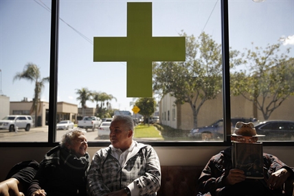 FILE - Kay Nelson, left, and Bryan Grode, retried seniors from Laguna Woods Village, chat in the lobby of Bud and Bloom cannabis dispensary while waiting for a free shuttle to arrive in Santa Ana, Calif., Feb. 19, 2019. A federal proposal to reclassify marijuana as a less dangerous drug has raised the hopes of some pot backers that more states will embrace cannabis.